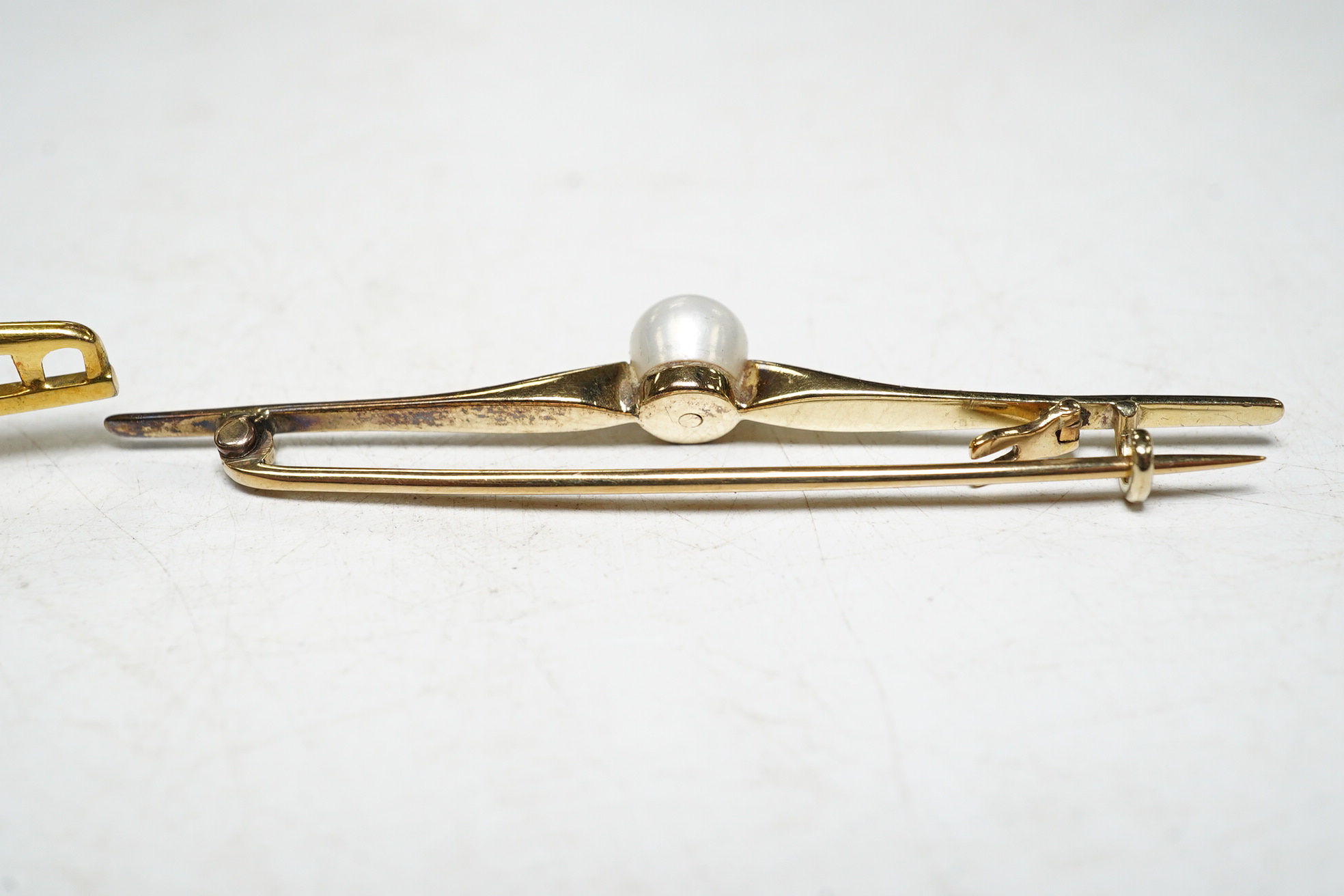 A 9ct gold split pearl and enamel set bar brooch, 1.9 grams, and a cased yellow metal pearl set bar brooch. Condition - good